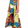 Vestido largo tropical anudado al cuello con estampado de manchas y hojas en verde lima - Vista frontal completa - Ana Faura